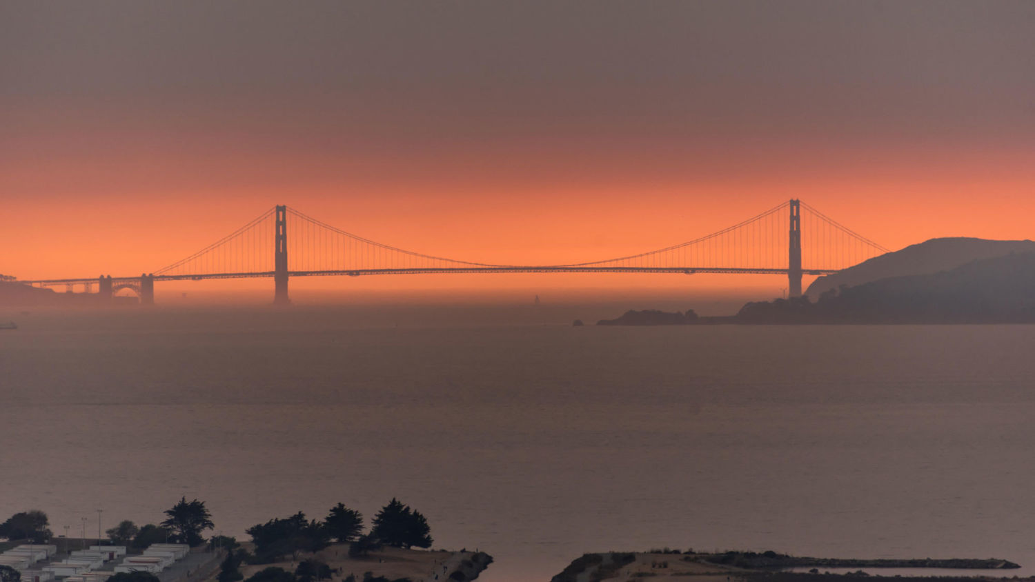 Smoke from wildfires creates an orange haze behind the Golden Gate Bridge in San Francisco.